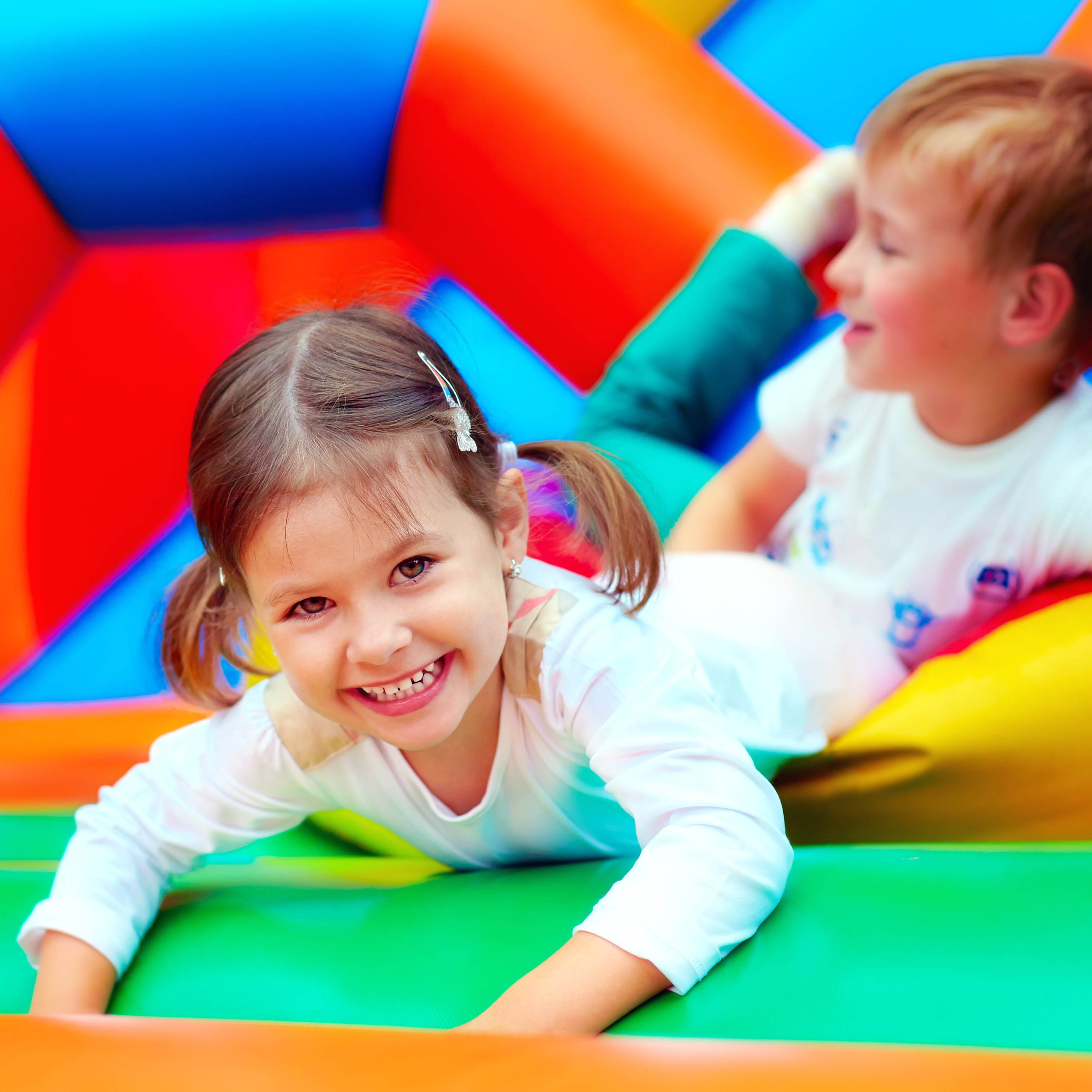 happy kids having fun on playground in kindergarten